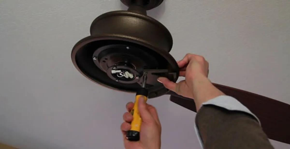 Electrician installing ceiling fan mounting bracket and fixture in Cape Coral, FL
