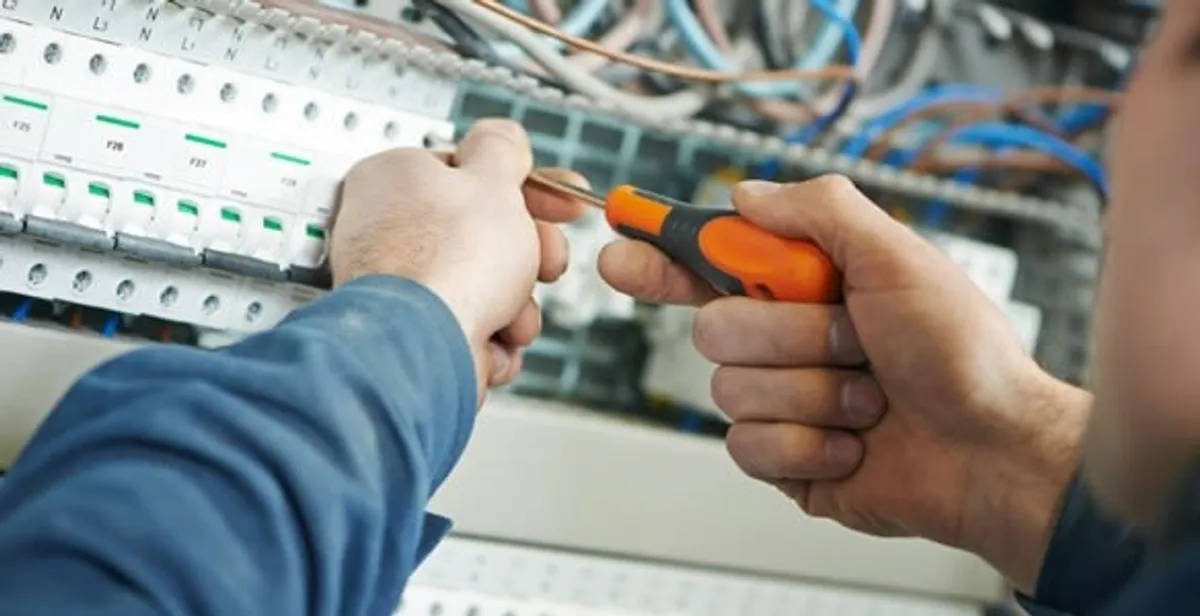 electrical service showing licensed electrician performing electrical panel maintenance and adjustments in Cape Coral, FL