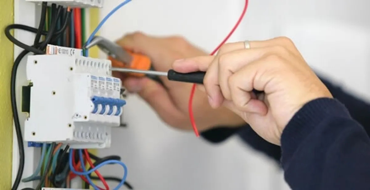 Electrician installing and adjusting circuit breakers in an electrical panel in Cape Coral, FL