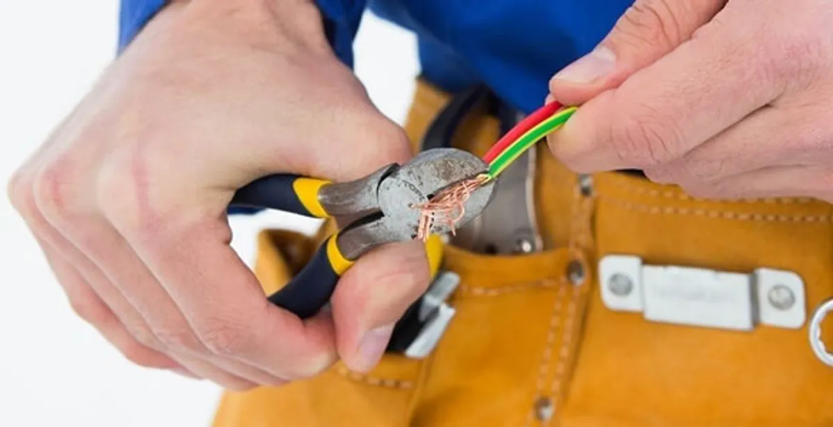 licensed electrician securing electrical wiring with professional tools during service work in Cape Coral, FL